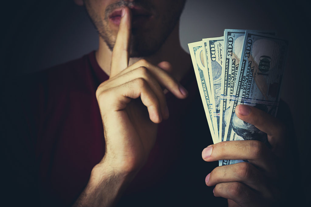 Bribery people with dollar bills in hand and quiet gesture
