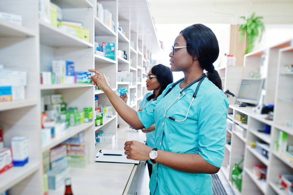 Pharmacist choosing medication from a shelf