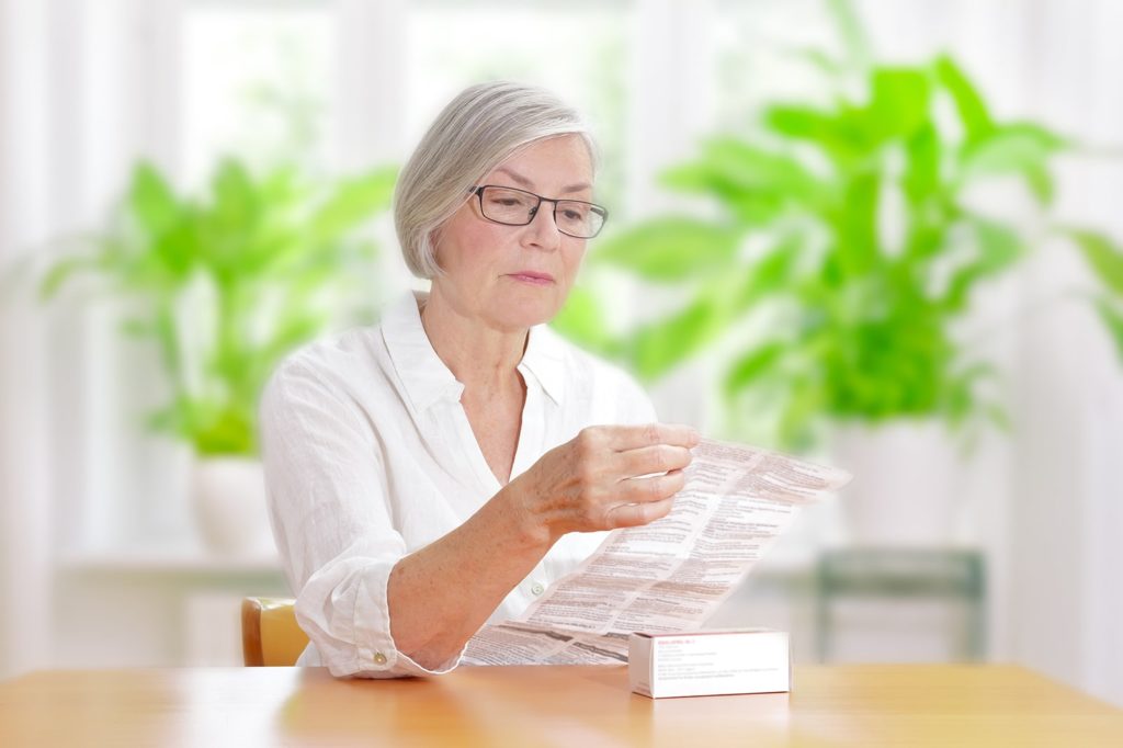 Woman reading medication instructions